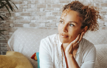 pensive woman in tight curly hair sitting on the couch Martinez, GA